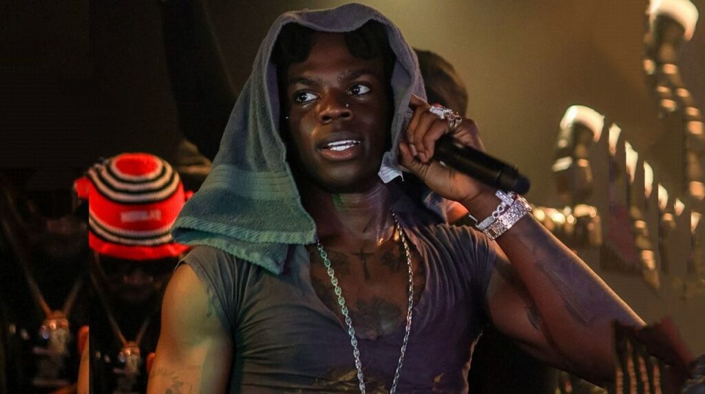 Headshot of Rema holding a mic