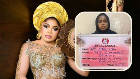 Bobrisky holding a mugshot