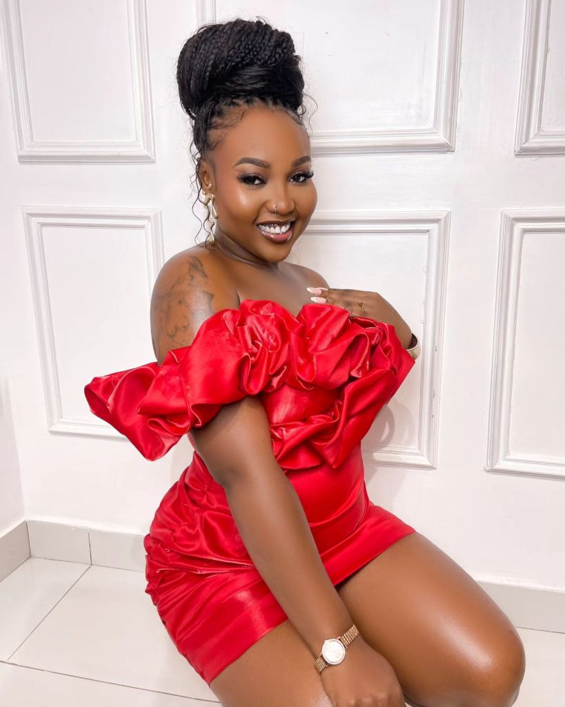 Rhuthee dons a bold red dress with statement ruffles.