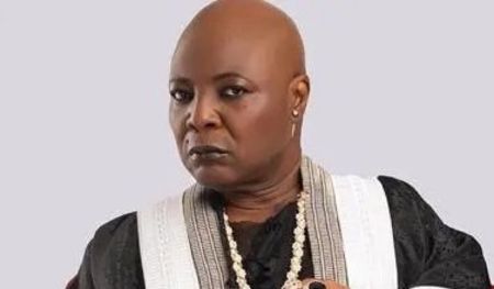 Veteran singer Charly Boy wearing a black outfit with white details and multiple necklaces.