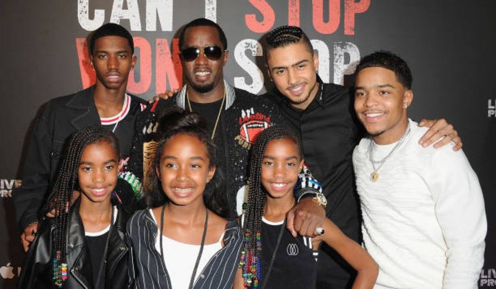 Sean Diddy Combs at an event with six children, standing in front of a backdrop that reads “Can’t Stop Won’t Stop.”