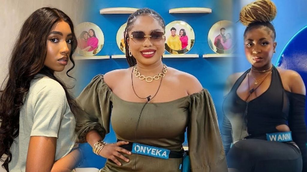 BBNaija stars Anita, Onyeka, and Wanni standing together in front of a blue background with circular shelves displaying photos. Onyeka is in the center wearing a green top, while Anita and Wanni are on either side in black and grey tops.
