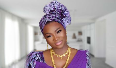 Therapist Jaruma is pictured wearing a vibrant, patterned dress with bold colors. She has a confident expression, with her hair styled in loose waves and accessorized with statement jewelry.