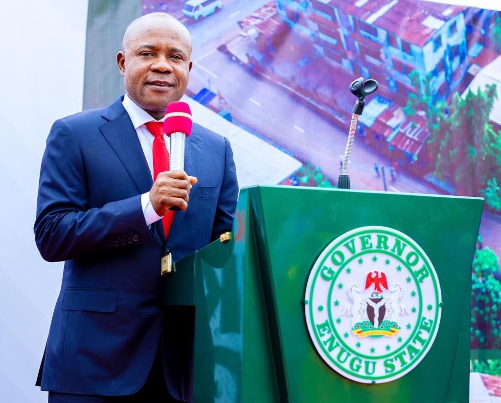 Governor Peter Mbah holding a microphone during the commissioning of Mike Ejeagha Road in Abakpa Enugu