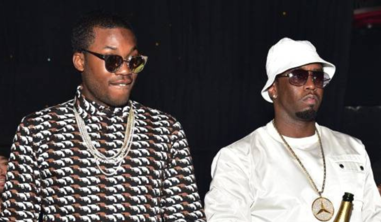 Sean ‘Diddy’ Combs and Meek Mill posing together at an event, both dressed in stylish outfits and smiling for the camera.”