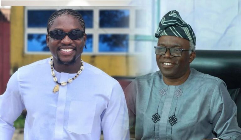 On the left, a smiling social media activist VeryDarkMan wearing sunglasses and a white shirt with a beaded necklace; on the right, a human rights lawyer Femi Falana dressed in traditional attire, seated and smiling at the camera. The background includes blurred elements of a building.