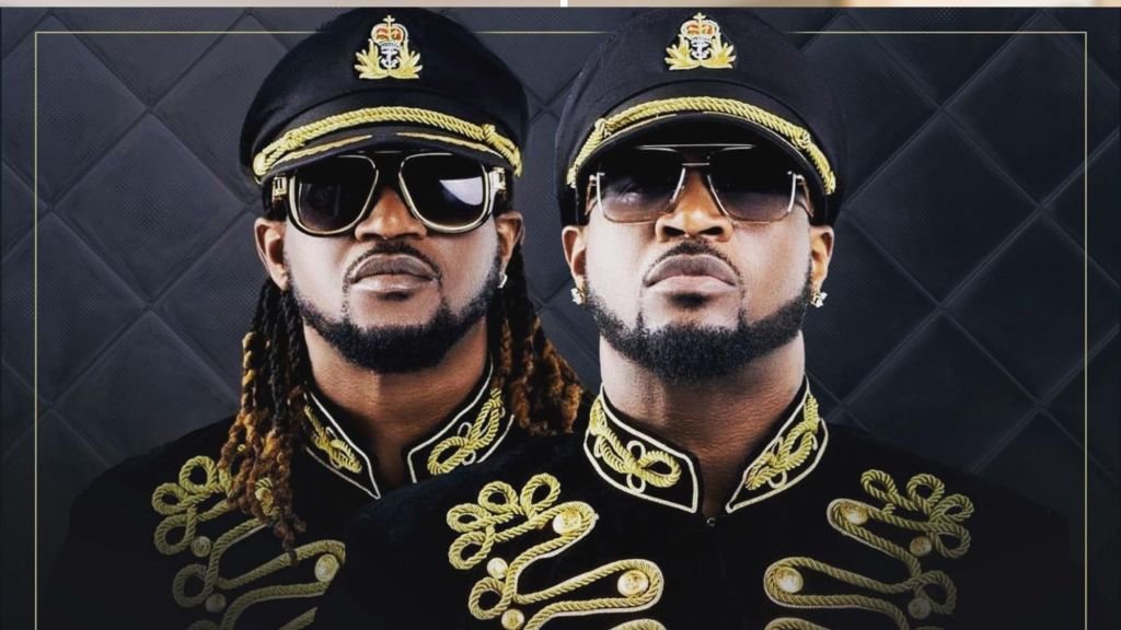 Psquare, the Nigerian music duo and twin brothers, in ornate black and gold military-style jackets. Faces pixelated for privacy.