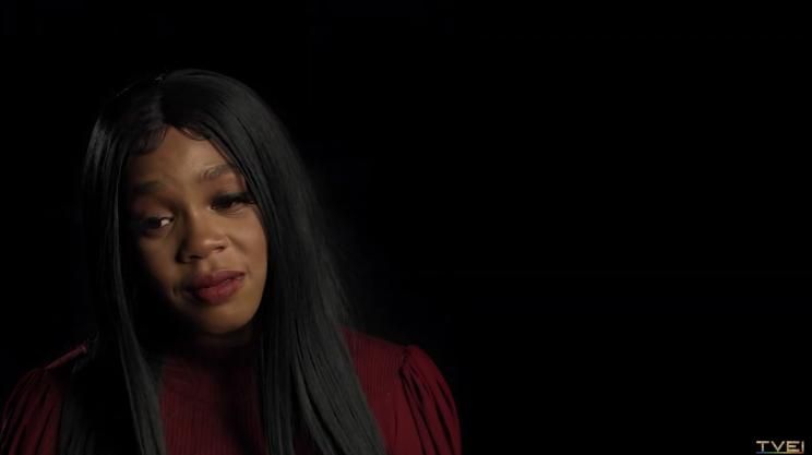 A close-up of Joanne with long hair appearing emotional