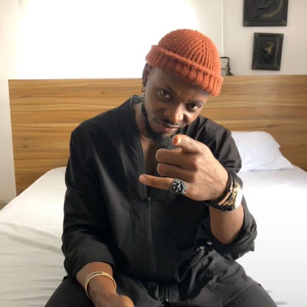 Kellyrae strikes a pose with a playful gesture.