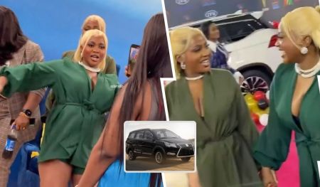 BBNaija Wanni and Handi both dressed in stylish green outfits, share a joyful moment as they engage with each other, showcasing vibrant expressions. The background features colorful decorations and a vehicle, enhancing the lively atmosphere.