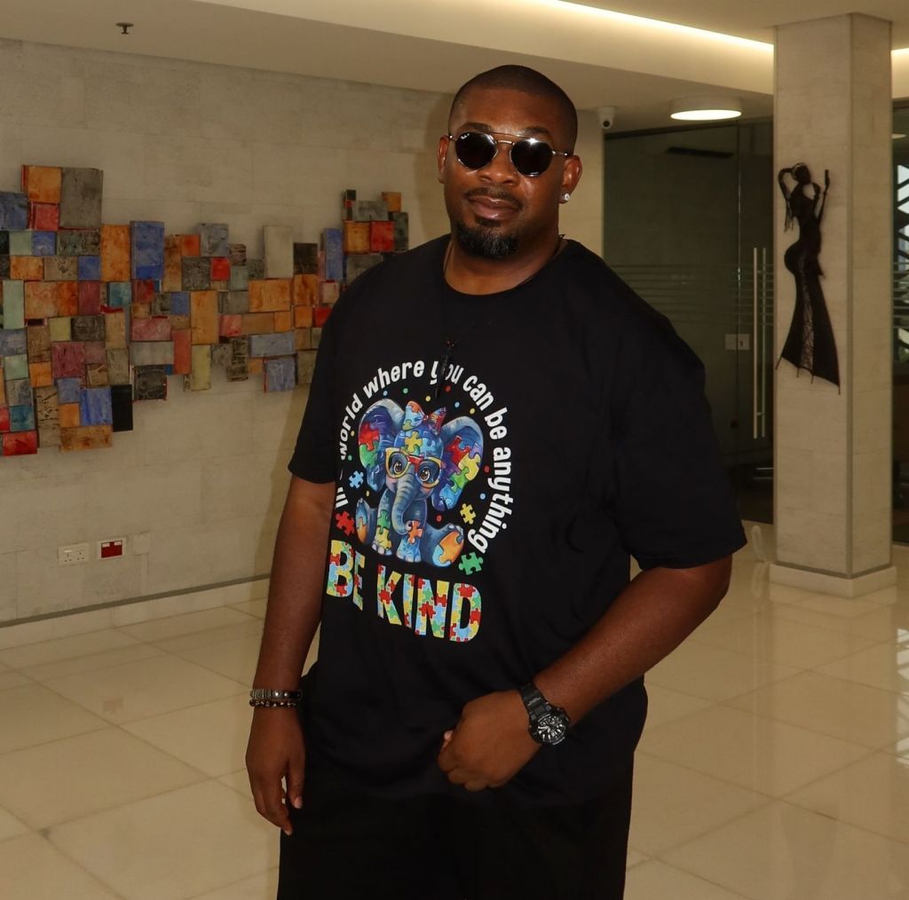 Don Jazzy is wearing sunglasses and a black T-shirt.