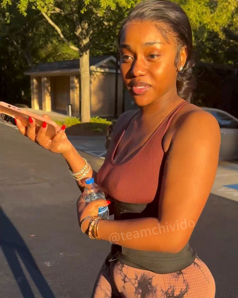 A joyful moment featuring Chioma, smiling as she engages with friends outdoors. Sunlight enhances the lively atmosphere.