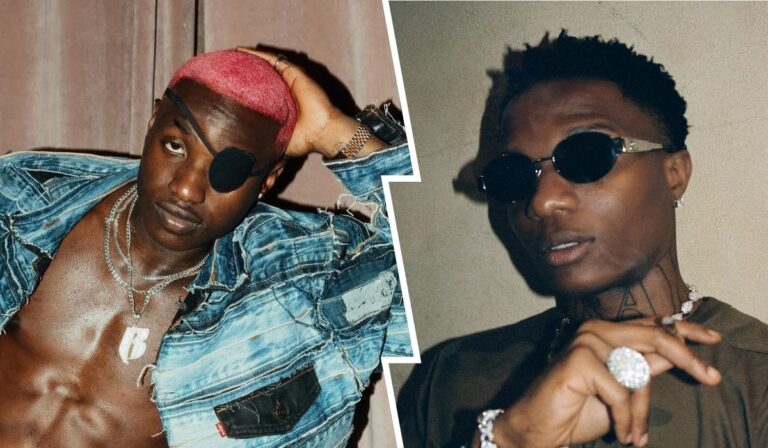 Ruger, sporting vibrant pink hair and an eye patch, poses confidently in a distressed denim jacket, while Wizkid, wearing sunglasses and jewelry, strikes a stylish pose. Both artists exude charisma against a soft, neutral backdrop.