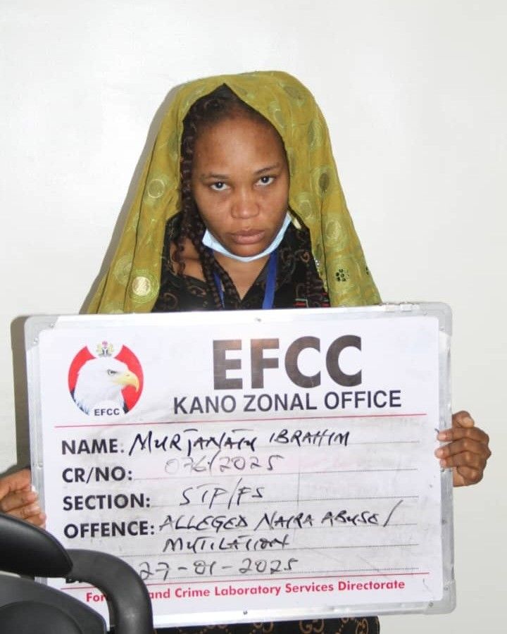 Murja Kunya, a TikTok star, is seen holding a placard from the EFCC Kano Zonal Office. The placard displays her name, case reference number CR/NO: 026/2023, and mentions an allegation of naira abuse/mutilation under section SIP/FS, dated 27-01-2023.