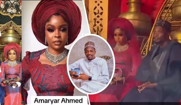 A collage featuring footballer Ahmed Musa and his fourth wife, Asmau Moriki. Asmau is dressed in an elegant red traditional outfit with a matching headwrap, adorned with intricate jewelry, standing alongside another woman in a similar attire. Ahmed Musa is seen in a white traditional outfit with a cap, smiling while holding a phone. The couple is also depicted sitting together in a luxurious setting with golden decor, Asmau in a red gown and Ahmed in a dark robe. The text "Amaryar Ahmed" is displayed at the bottom.