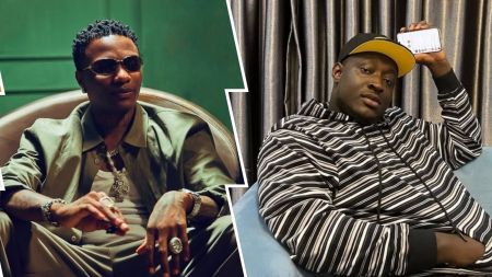 Singer Wizkid appears seated in a green jacket layered over a white shirt, accessorized with bold jewelry, while skitmaker Caterefe lounges on a blue couch in a striped hoodie and cap, focused on his phone. Contrasting backdrops—green and grey—frame each figure, highlighting their individual styles.