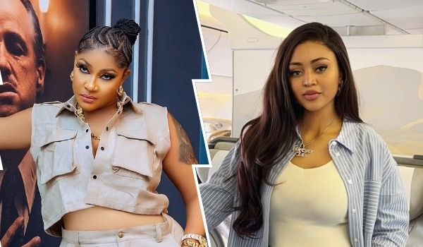 A collage featuring actresses Angela Okorie on the left and Regina Daniels on the right. Angela Okorie is styled with braided hair in a high bun, wearing a sleeveless beige cargo top with matching pants, accessorized with gold jewelry and standing in front of a dramatic backdrop. Regina Daniels has long, straight hair, dressed in a light blue striped shirt over a cream top, with a pendant necklace, seated in what appears to be a modern, light-colored interior, possibly on an airplane.