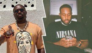 Activist VeryDarkMan stands outdoors in a vibrant orange shirt featuring a patterned face design, accessorized with multiple necklaces and rings, pointing forward confidently. BBNaija star Kiddwaya sits indoors, wearing a black Nirvana t-shirt, holding a phone, with a presentation screen in the background.