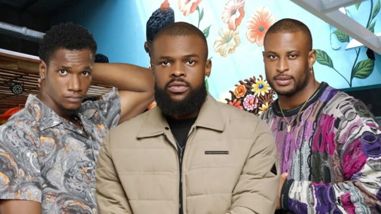 BBNaija Season 10 housemates Danboskid, Denari, and Kaybobo posing inside the Big Brother Naija house, with a vibrant floral mural in the background.