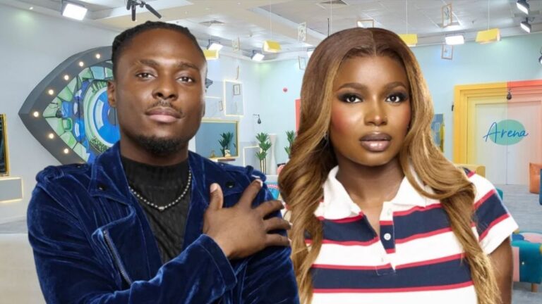 BBNaija Season 10 housemates Faith and Isabella posing inside the Big Brother Naija house, with the iconic eye logo and colourful lounge area visible in the background.