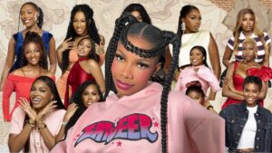 Former BBNaija star Tacha in a pink hoodie posing in front of a collage featuring all the female housemates of BBNaija Season 10.
