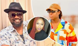Jude Okoye sports a black hat and a tropical-print shirt with palm trees and sailboats, while Cynthia Morgan, aka Madrina, wears a vibrant patterned shirt and a brown cap with a circular emblem. A smaller inset shows a person with long red braids in a dark shirt.
