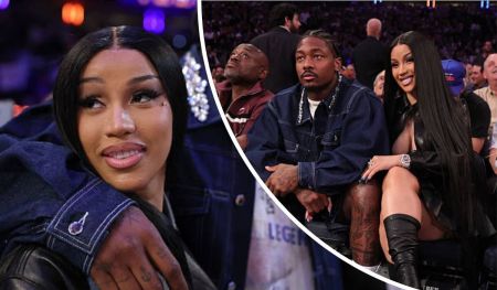 Cardi B, dressed in a black leather outfit and thigh-high boots, sits beside Stefon Diggs, who sports a denim jacket and visible hand tattoos, at a lively sports arena surrounded by spectators.