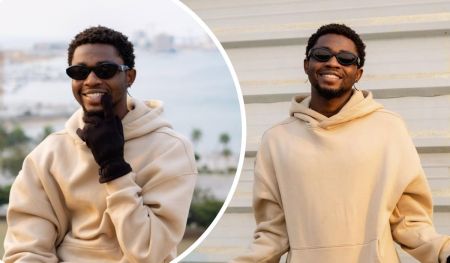 Two side-by-side photos of singer Omah Lay wearing a beige hoodie and dark sunglasses, with one shot showing him outdoors near water and the other against a striped wall background.