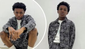 A collage featuring singer Small Doctor in two poses, wearing a matching black patterned jacket and shorts with a white shirt underneath, against a plain white background. One pose shows him crouching with hands extended, while the other depicts him standing with hands in pockets.