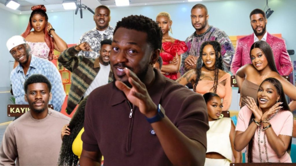 Former BBNaija star Adekunle Olopade pictured in front of Big Brother Naija Season 10 housemates posing inside the house. The housemates include both male and female contestants dressed in vibrant outfits.