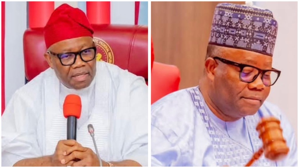 Senator Akpabio in traditional attire speaking into a microphone on a red chamber seat and also him looking down beside a gavel.