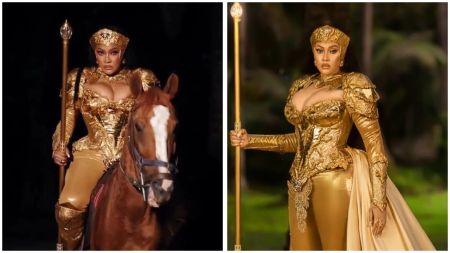 Angela Okorie stuns in gold warrior-themed outfit, holding a staff and posing with a horse in regal birthday photoshoot.