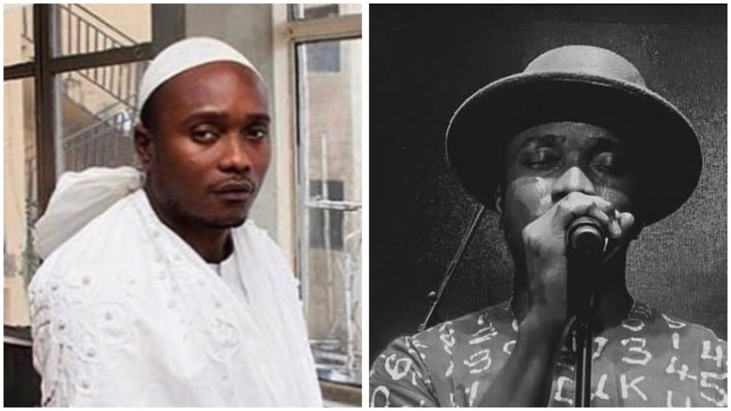 Brymo in a white embroidered outfit and head wrap and in a wide-brim hat singing into a microphone on stage, face lit and slightly sweaty against a dark background