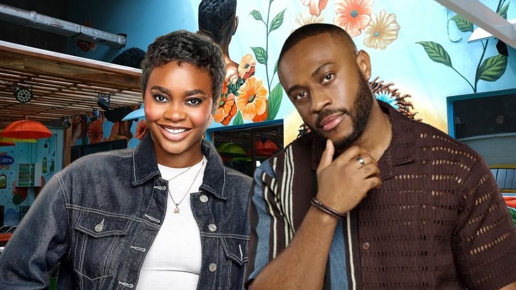 BBNaija Season 10 housemates Dede and Lola posing inside the Big Brother Naija house. Dede is smiling in a denim jacket, while Lola stands beside her in a dark striped shirt with his hand on his chin. A vibrant floral mural serves as the background.