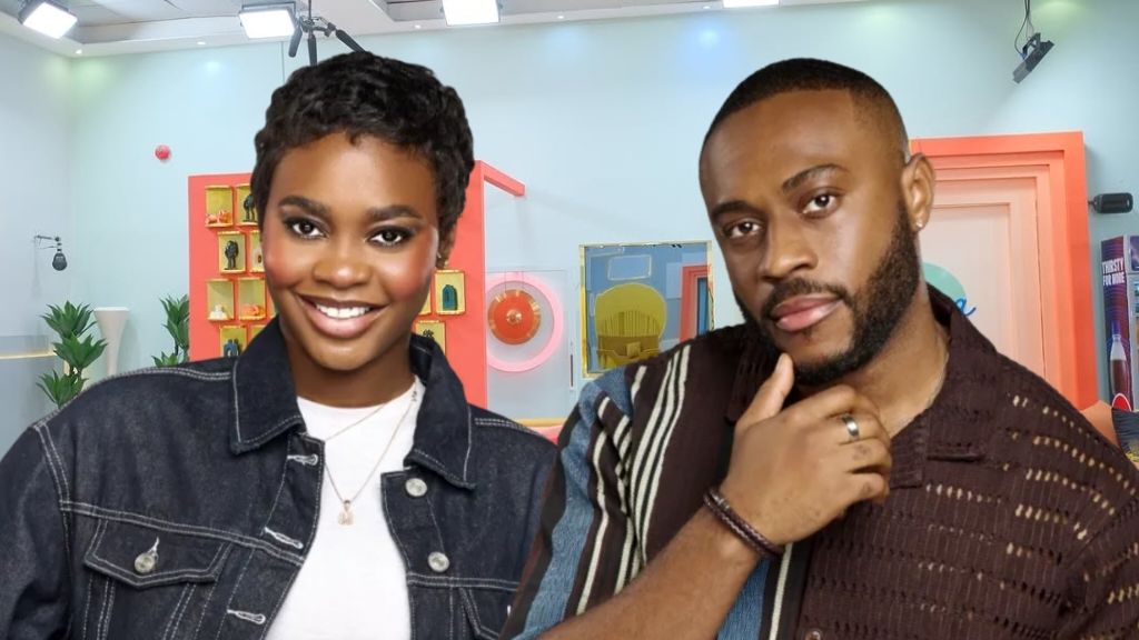 BBNaija Season 10 housemates Dede and Kola pose stylishly inside the Big Brother house arena with a colourful set behind them.