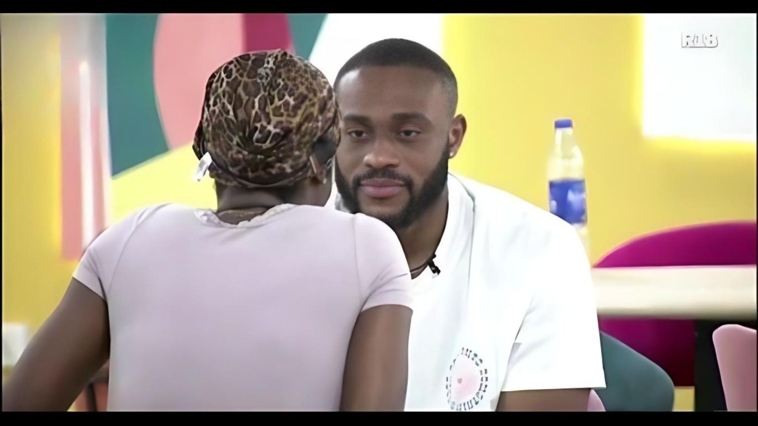 BBNaija Season 10 housemates Dede and Kola share an intense face-to-face moment inside the Big Brother Naija house, with Kola staring directly at Dede during a conversation.