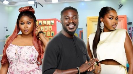 BBNaija Season 10 housemates Imisi, Otega and Sabrina posing inside the Big Brother Naija house. Imisi is dressed in a floral dress with long reddish hair, Otega is wearing a black outfit while smiling, and Sabrina is in a cream two-piece outfit with statement earrings.