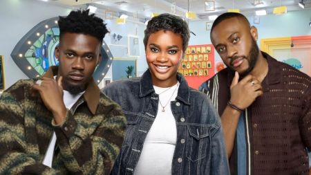 BBNaija Season 10 housemates Jason Jae in a patterned jacket, Dede in a denim jacket, and Kola in a brown striped shirt posing inside the Big Brother house.