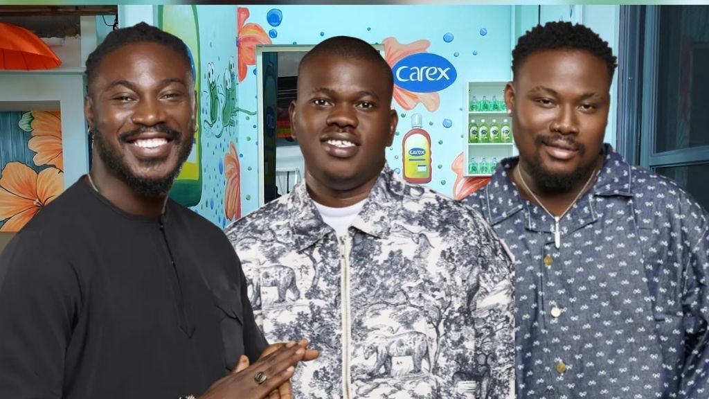 BBNaija Season 10 housemates Otega, Kuture, and Rooboy standing together inside the Big Brother Naija house, smiling and dressed in casual patterned outfits.