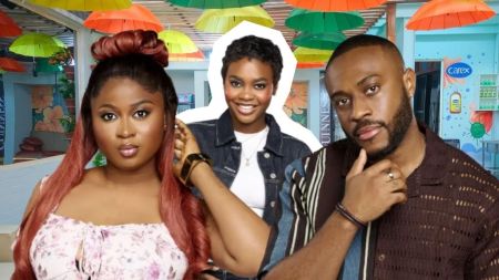 BBNaija Season 10 housemates Imisi, Dede, and Kola pose together inside the Big Brother Naija house, with Imisi in a floral top, Dede in a denim jacket, and Kola in a brown patterned shirt.