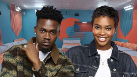 Big Brother Naija Season 10 housemates Jason Jae and Dede pose inside the house. Jason Jae strikes a serious look in a patterned jacket, while Dede smiles brightly in a denim jacket.