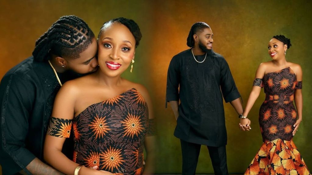 BBNaija star Praise sweetly poses with his fiancée in matching black and orange Ankara outfits, holding hands and sharing a romantic moment during their engagement photoshoot.