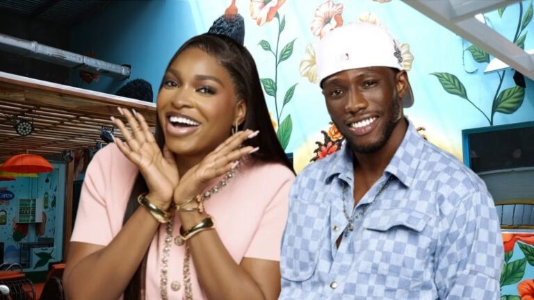 BBNaija Season 10 housemates Thelma Lawson and Kayikunmi flash bright smiles as they pose side by side in front of a floral-themed wall inside the Big Brother house.