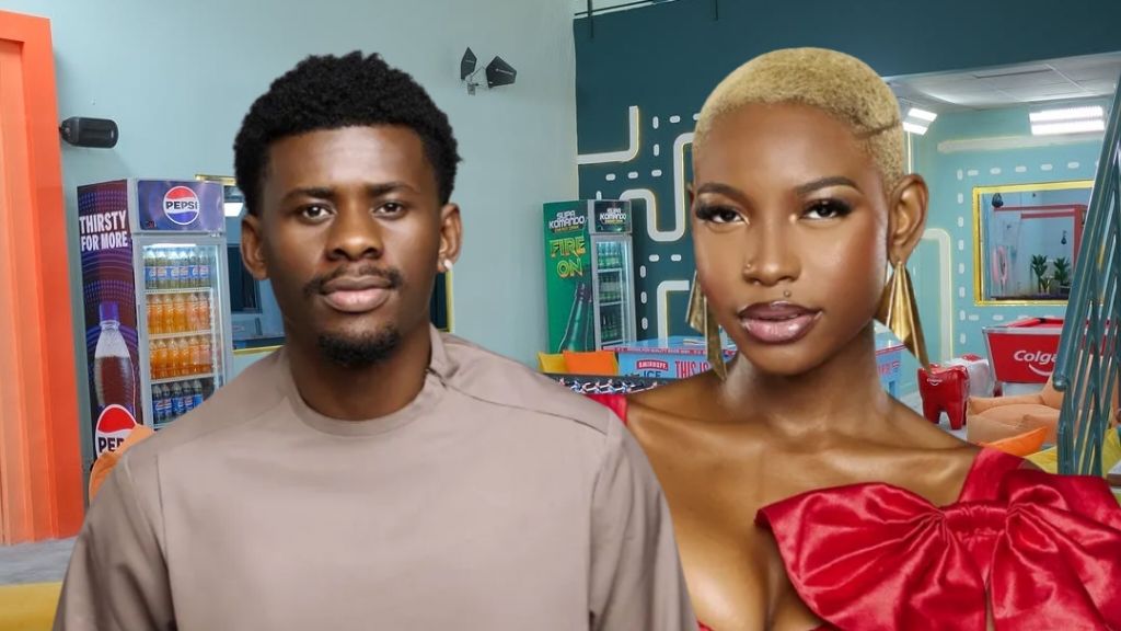 BBNaija Season 10 housemates Victory and Joanna posing inside the Big Brother Naija house, with Victory in a beige long-sleeve top and Joanna wearing a bold red dress with an oversized bow detail, sporting short blonde hair and statement earrings.