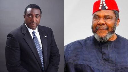 Nollywood actors Bob Manuel Udokwu and Pete Edochie. Bob Manuel is dressed in a black suit with a blue tie, posing formally against a dark backdrop. Pete Edochie wears a dark native attire with a red Igbo cap decorated with white cowries, smiling slightly.