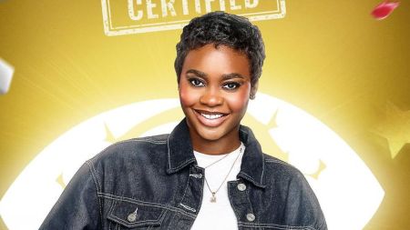 BBNaija Season 10 housemate Dede smiles in a promotional portrait, wearing a denim jacket over a white top, with a gold necklace, against a yellow background featuring the Big Brother Naija logo.