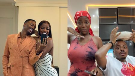 Nigerian couple Elioluwa and Hilda smiling while taking a mirror selfie indoors. Elioluwa is dressed in a peach double-breasted suit, while Hilda wears a fitted black-and-white striped dress.