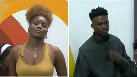 BBNaija Season 10 housemates Isabella and Jason Jae pictured during a tense moment in the house. Isabella is seen in a mustard-yellow tank top while Jason Jae appears in a dark grey zip-up top, both with serious expressions.