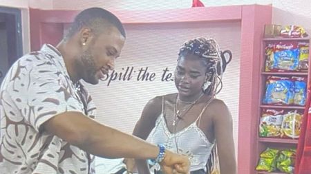 BBNaija Season 10 housemates Dede and Kaybobo share a moment during a conversation inside the lounge, with snack shelves visible in the background.