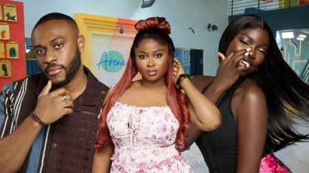 BBNaija Season 10 housemates Kola, Imisi, and Zita posing inside the Big Brother Naija house, dressed stylishly with the colourful lounge background behind them.